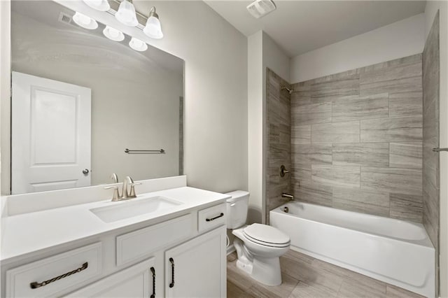 full bathroom with vanity, toilet, and tiled shower / bath