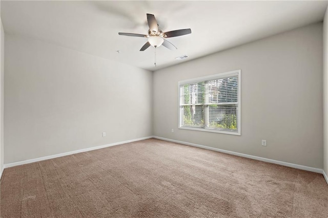 empty room with ceiling fan and carpet floors