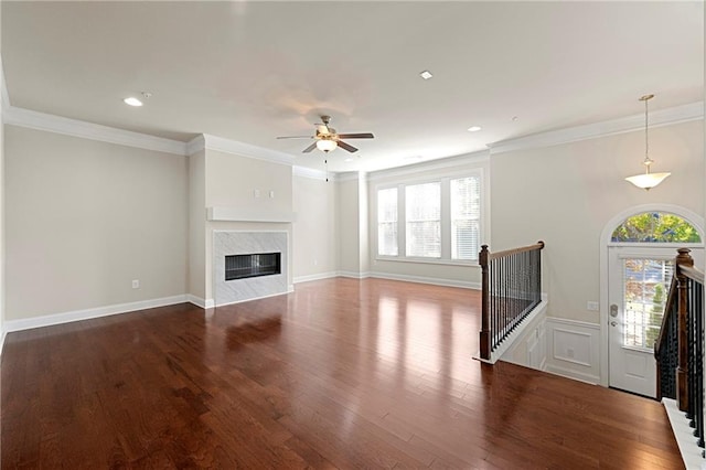 unfurnished living room featuring dark hardwood / wood-style floors, plenty of natural light, and a premium fireplace