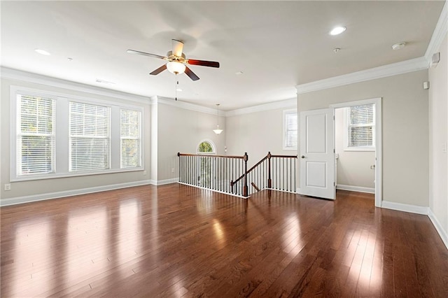 unfurnished room with ornamental molding, plenty of natural light, dark wood-type flooring, and ceiling fan