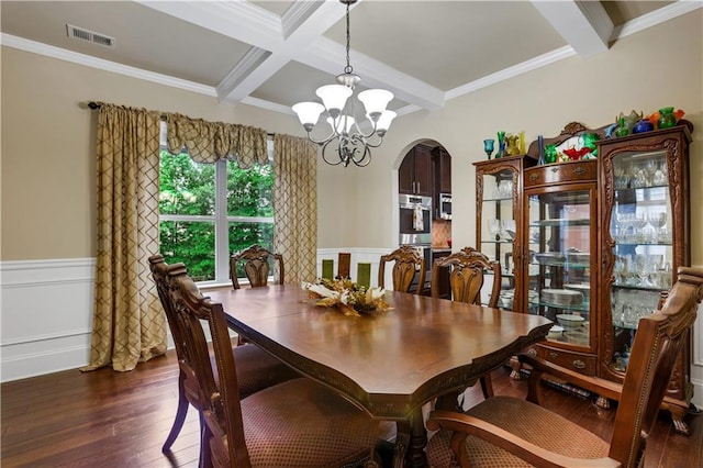 dining area with dark hardwood / wood-style flooring, a notable chandelier, crown molding, and beam ceiling