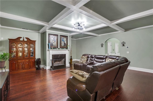 living room with dark hardwood / wood-style flooring, coffered ceiling, an inviting chandelier, and beam ceiling