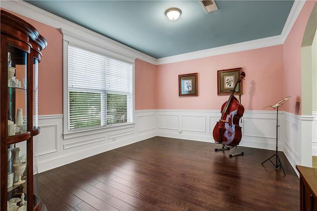 interior space with dark hardwood / wood-style flooring and crown molding