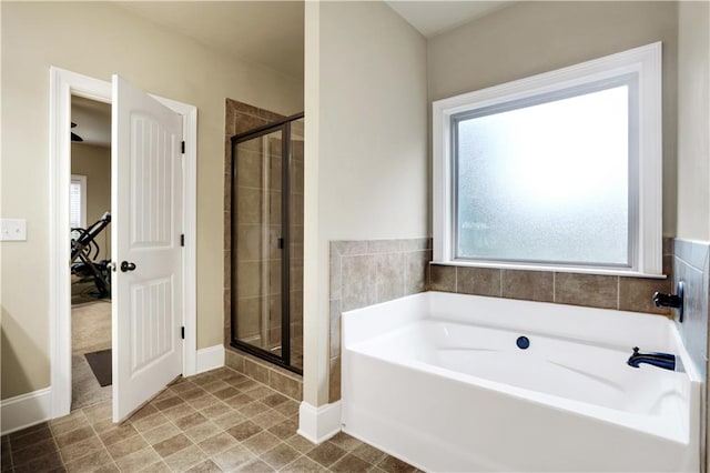 bathroom featuring separate shower and tub