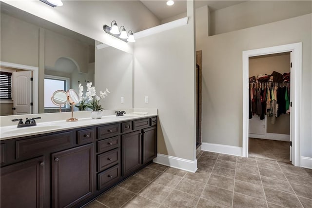 bathroom featuring a shower with door, vanity, and tile patterned flooring