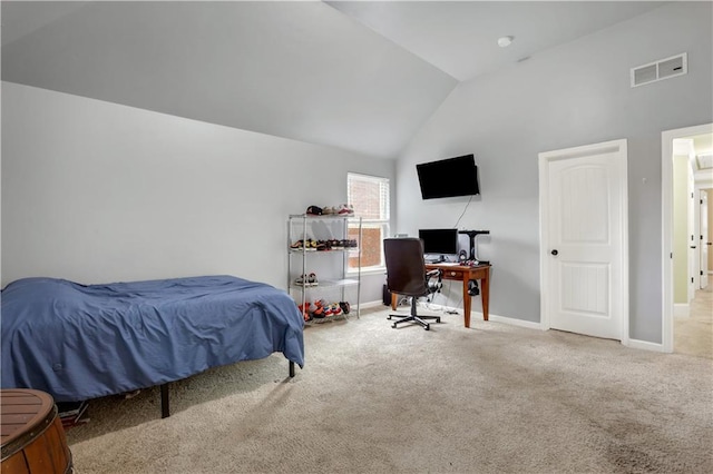 carpeted bedroom featuring high vaulted ceiling