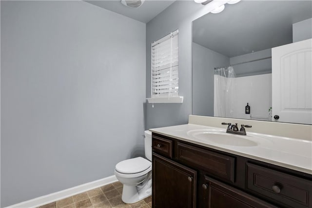 bathroom featuring vanity, toilet, and a shower with shower curtain