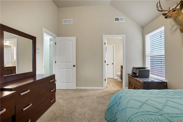 carpeted bedroom featuring connected bathroom and high vaulted ceiling