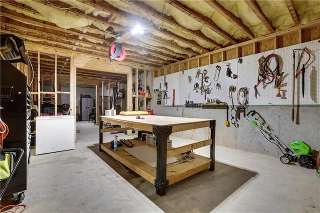 basement with a workshop area and washer / dryer