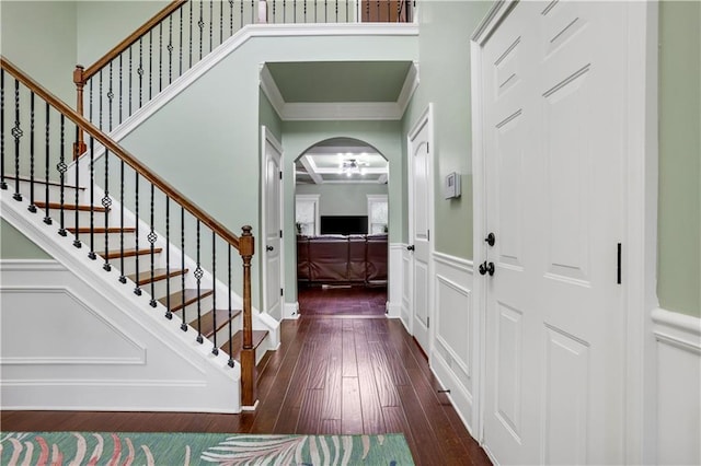 entrance foyer featuring dark hardwood / wood-style flooring and ornamental molding