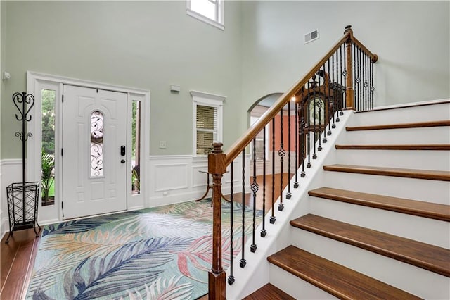 entrance foyer featuring a high ceiling and dark hardwood / wood-style floors