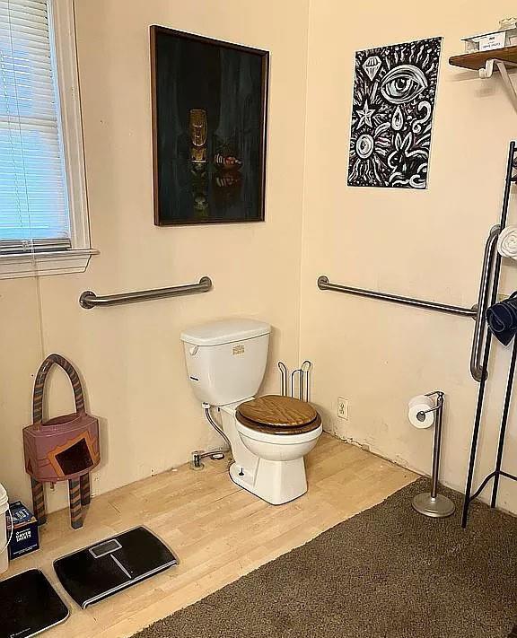 bathroom with toilet and hardwood / wood-style floors