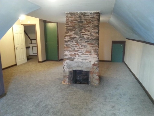 additional living space featuring carpet, lofted ceiling, and a fireplace