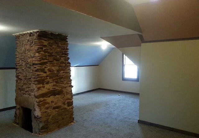 bonus room featuring carpet flooring and vaulted ceiling