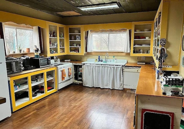 kitchen with white appliances, sink, white cabinetry, dark hardwood / wood-style floors, and wooden ceiling