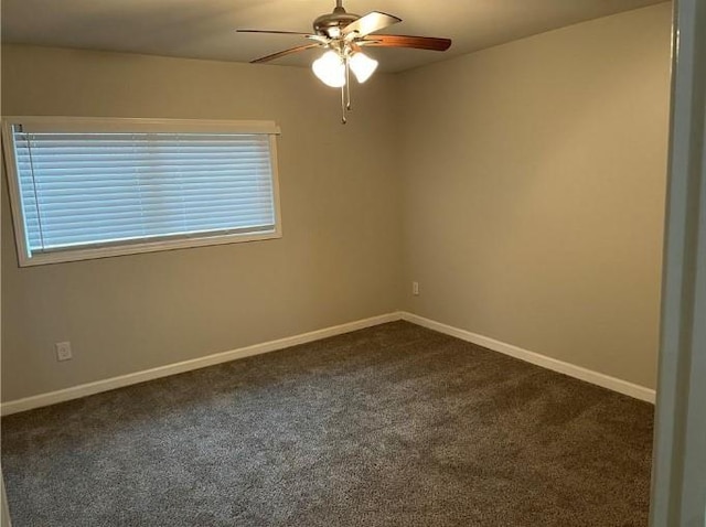 unfurnished room with dark carpet and ceiling fan