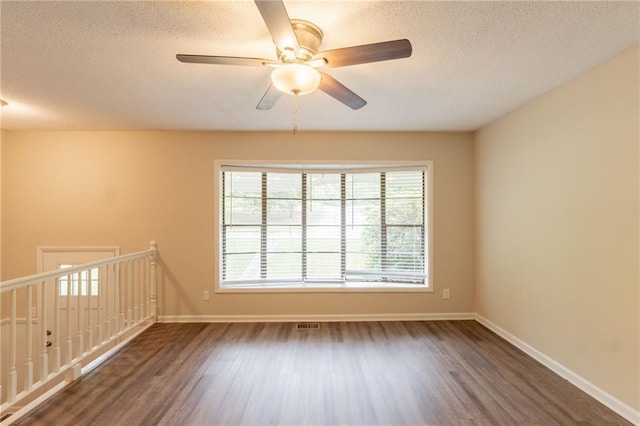 4669 Birch Ridge Trl, Stone Mountain, GA 30083 - unfurnished room with wood finished floors, a textured ceiling, ceiling fan, and baseboards