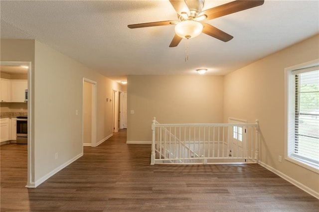 4669 Birch Ridge Trl, Stone Mountain, GA 30083 - unfurnished room with dark wood-style flooring, baseboards, and a ceiling fan