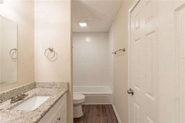 4669 Birch Ridge Trl, Stone Mountain, GA 30083 - bathroom featuring toilet, vanity, wood finished floors, bathing tub / shower combination, and baseboards
