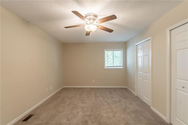 4669 Birch Ridge Trl, Stone Mountain, GA 30083 - unfurnished bedroom with light carpet, a textured ceiling, a closet, baseboards, and ceiling fan