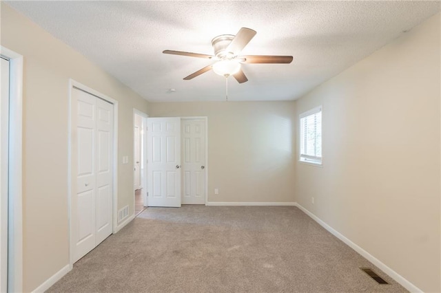4669 Birch Ridge Trl, Stone Mountain, GA 30083 - unfurnished bedroom featuring carpet flooring, a textured ceiling, baseboards, and a ceiling fan