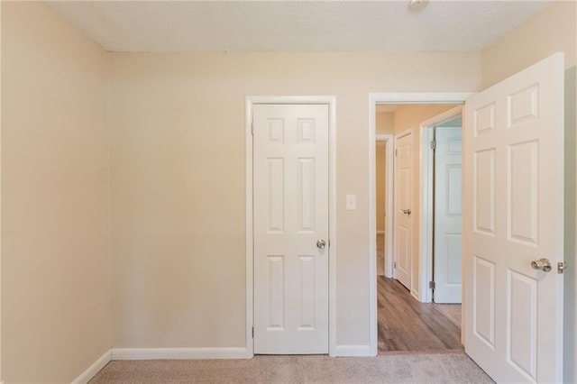 4669 Birch Ridge Trl, Stone Mountain, GA 30083 - unfurnished bedroom featuring baseboards and light carpet