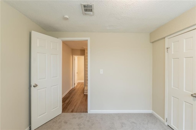 4669 Birch Ridge Trl, Stone Mountain, GA 30083 - unfurnished bedroom with carpet flooring, baseboards, and a textured ceiling