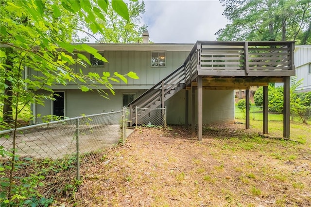 4669 Birch Ridge Trl, Stone Mountain, GA 30083 - back of property featuring stairway, a wooden deck, a carport, and a chimney