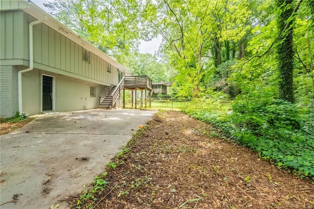 4669 Birch Ridge Trl, Stone Mountain, GA 30083 - view of yard featuring stairway, a deck, driveway, and a patio