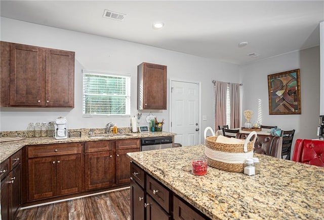 kitchen featuring light stone counters, dishwasher, dark hardwood / wood-style floors, dark brown cabinets, and sink