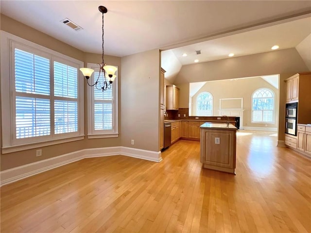 kitchen with stainless steel appliances, visible vents, light wood-style floors, open floor plan, and a chandelier