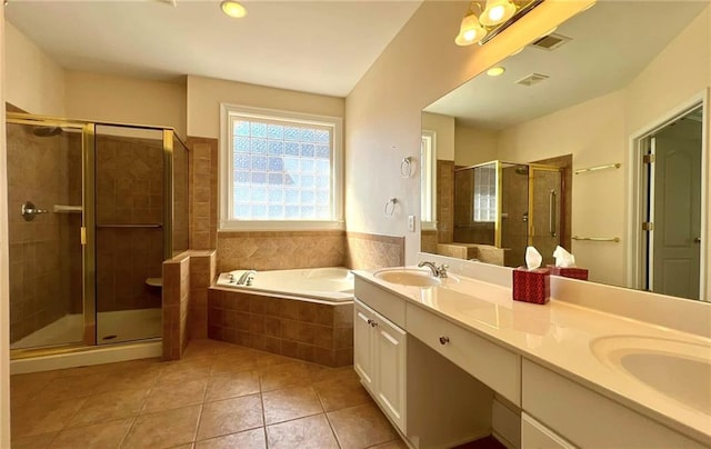 full bath with visible vents, a sink, tile patterned flooring, a shower stall, and a bath