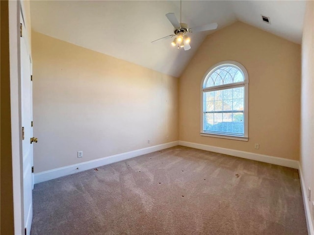 spare room featuring lofted ceiling, baseboards, and carpet floors