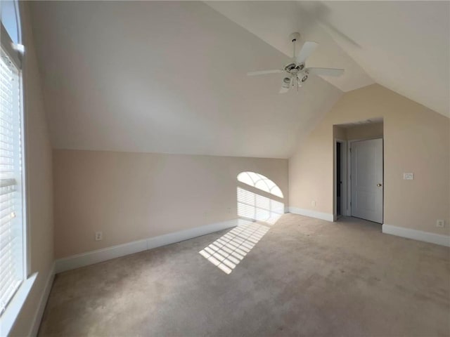 bonus room with carpet floors, lofted ceiling, ceiling fan, and baseboards