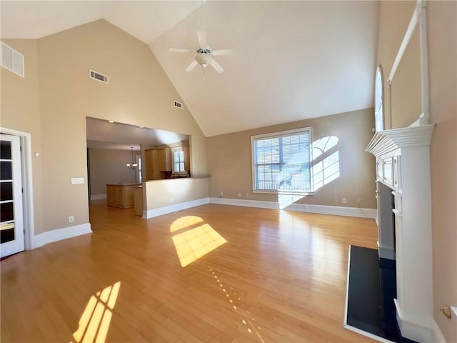 unfurnished living room featuring baseboards, light wood-style flooring, visible vents, and a ceiling fan