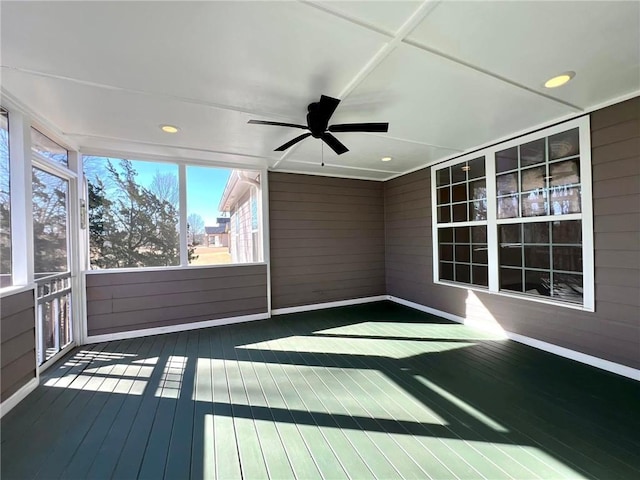 unfurnished sunroom with ceiling fan