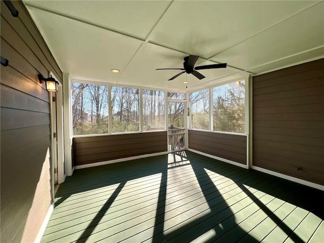 unfurnished sunroom featuring ceiling fan