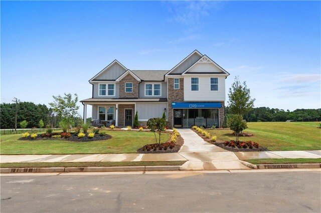 craftsman-style home featuring a front yard and a porch