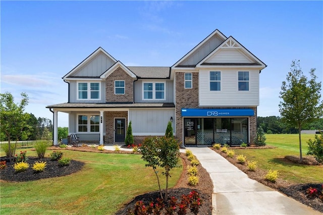 craftsman house with a front yard and covered porch