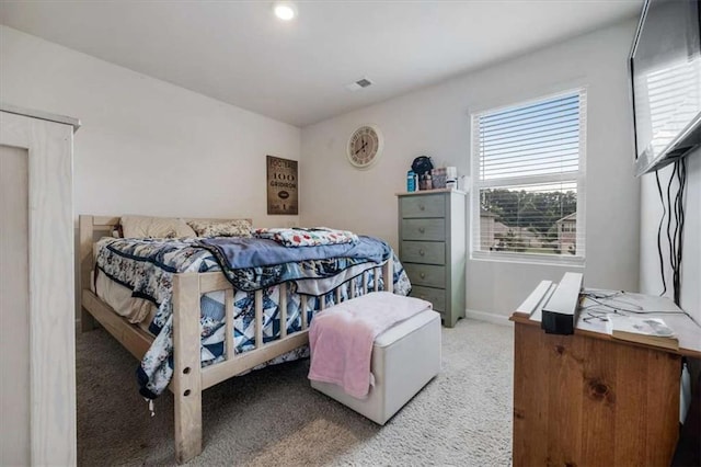 carpeted bedroom with visible vents and baseboards