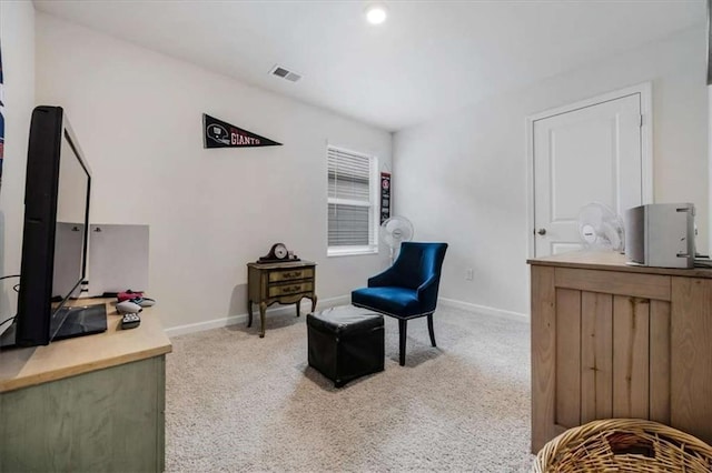 sitting room with visible vents, carpet floors, and baseboards