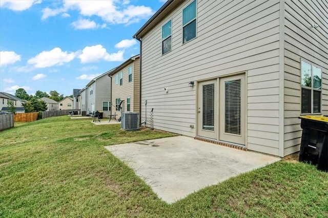 back of house featuring fence, a yard, a patio, and a residential view