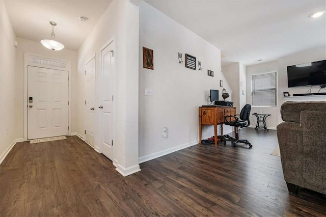 interior space featuring dark wood-style floors and baseboards