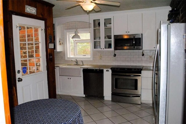 kitchen with backsplash, stainless steel appliances, and white cabinetry