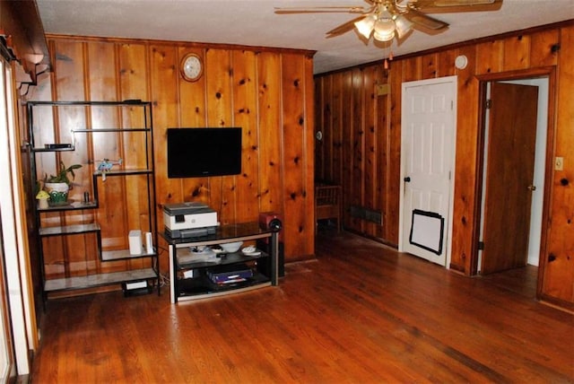 living room featuring ceiling fan and dark hardwood / wood-style floors