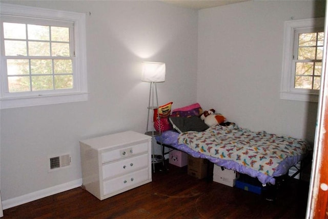 bedroom with dark wood-type flooring