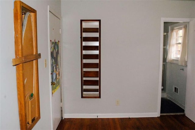 hallway with dark hardwood / wood-style floors