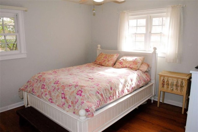 bedroom with ceiling fan and dark wood-type flooring