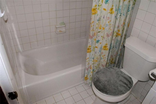 bathroom featuring toilet, tile patterned flooring, and shower / bath combo