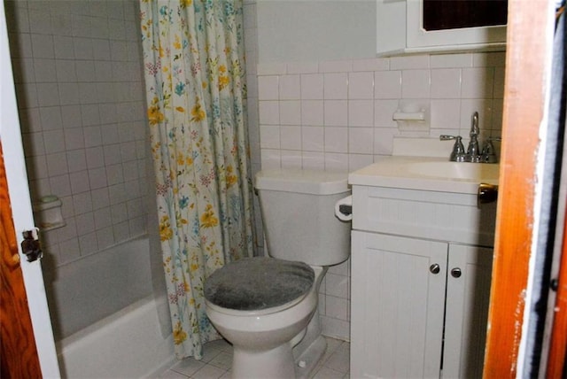 full bathroom with tile patterned flooring, vanity, tile walls, toilet, and shower / tub combo with curtain